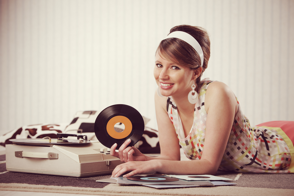 Vintage-looking woman surrounded by vinyl records